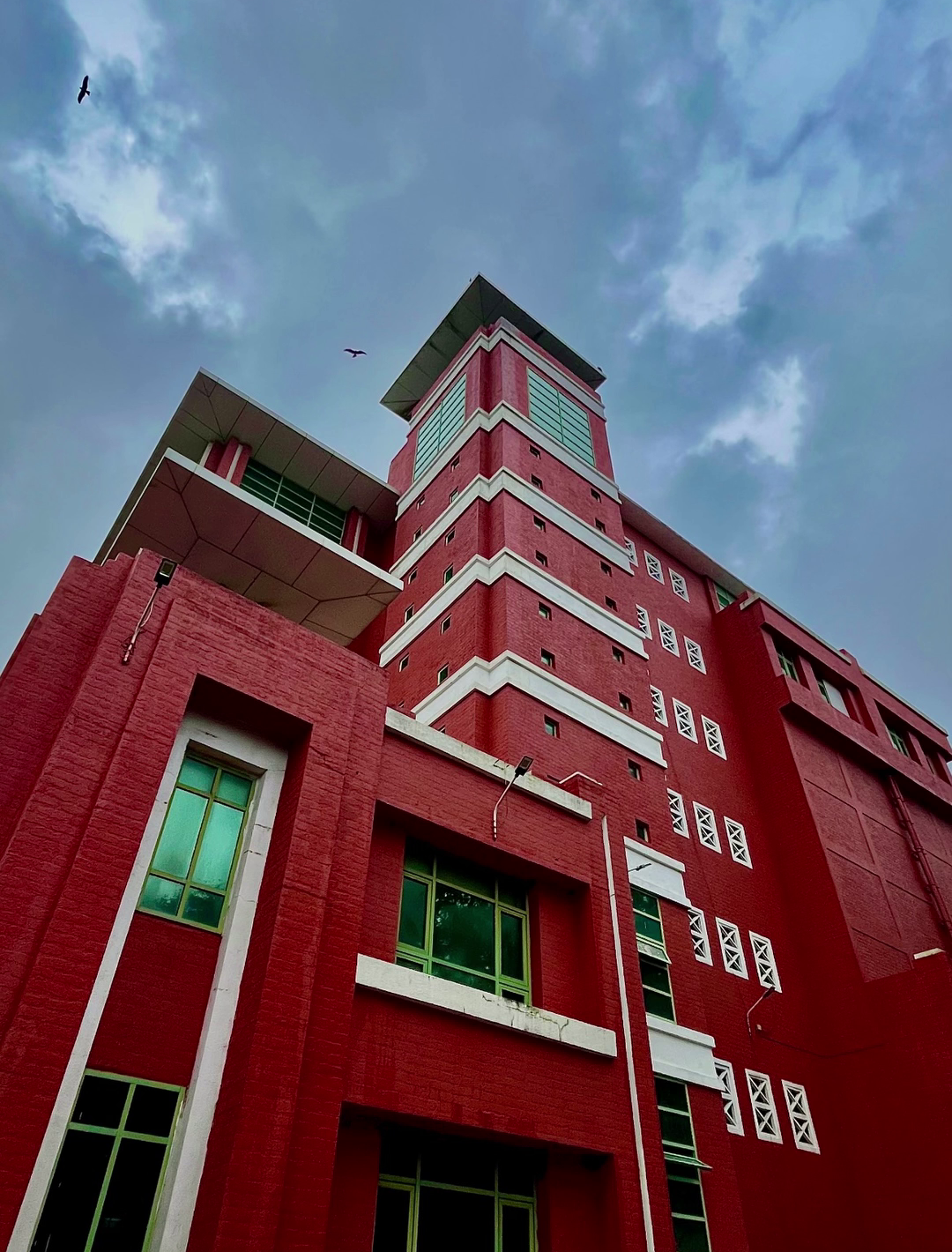 IIM Mumbai iconic red-brick academic tower against sky